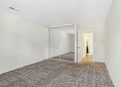 Thumbnail 36 of 57 - A room with a carpeted floor and a glass door. at Millennium at Creve Coeur, Creve Coeur