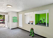 Thumbnail 28 of 38 - A room with a green wall and a mirror.