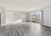 Thumbnail 29 of 45 - A spacious room with a grey floor and white walls at Spyglass Creek, Denver, 80224
