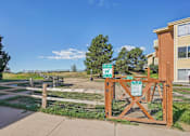 Thumbnail 34 of 41 - A wooden gate with a sign on it in front of a building.