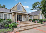Thumbnail 1 of 27 - A house with a front yard and steps leading to the front door.