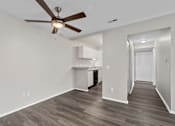 Thumbnail 4 of 57 - Bedroom with a ceiling fan and a kitchen in the background at Creve Coeur, Creve Coeur, MO