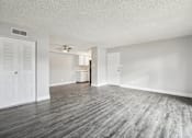 Thumbnail 11 of 45 - A room with a wooden floor and white walls at Spyglass Creek, Denver, 80224