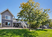 Thumbnail 44 of 44 - A grey house with a tree in front of it. at Windmill Apartments, Colorado Springs, Colorado