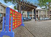 Thumbnail 6 of 27 - A large blue and red foosball table in the middle of a courtyard.