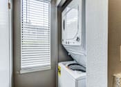 Thumbnail 32 of 37 - Laundry room has a washer and dryer and a window at Union Heights Apartments, Colorado Springs, CO