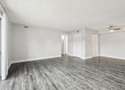 Thumbnail 12 of 45 - A room with a ceiling fan and wood flooring at Spyglass Creek, Denver, 80224