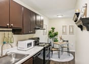 Thumbnail 6 of 35 - A kitchen with a white microwave on the counter. at Sarasota South Apartments, Bradenton