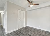 Thumbnail 14 of 45 - A room with a ceiling fan and a door at Spyglass Creek, Denver, 80224