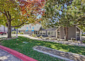 Thumbnail 26 of 44 - A tree with red leaves is in front of a house. at Windmill Apartments, Colorado Springs, CO, 80916