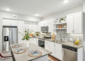 Thumbnail 1 of 86 - a kitchen with stainless steel appliances and white cabinets at Edge75, Naples, Florida 34104