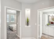 Thumbnail 25 of 86 - a bedroom and a bathroom with a bed and a mirror at Edge75, Naples, Florida 34104