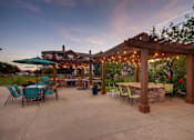 Thumbnail 31 of 45 - a patio with patio furniture and a pavilion with lights at Heritage at Stone Mountain, Northglenn, CO, 80233