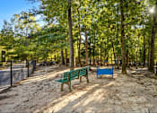 Thumbnail 43 of 43 - Dog park with wo benches in a park with trees at University Ridge Apartments, Durham, NC, 27707