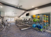 Thumbnail 14 of 22 - Gym with weights and cardio equipment and a ceiling fan at 2900 Lux Apartment Homes, Nevada