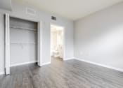 Thumbnail 36 of 117 - a bedroom with a medium sized bed and a closet with a sliding door at Heritage Bay, Jensen Beach, 34957