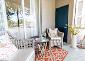Thumbnail 31 of 117 - a patio with two chairs and a table at Heritage Bay, Jensen Beach, FL
