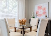 Thumbnail 27 of 117 - a dining room with a glass table and white chairs at Heritage Bay, Florida, 34957