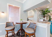 Thumbnail 113 of 117 - a bar area with two stools and a window at Heritage Bay, Florida