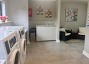 Thumbnail 46 of 51 - A laundry room with a washer and dryer.
