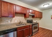 Thumbnail 1 of 24 - Kitchen with stainless steel appliances at River Crossing Apartments, Georgia
