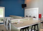 Thumbnail 21 of 23 - Laundry Room at The Pointe at Irving Park, Greensboro, NC