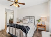 Thumbnail 16 of 64 - Bedroom with a bed and a ceiling fan at Lofts of Wilmington, Wilmington, NC
