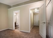 Thumbnail 12 of 31 - A bedroom with two doors and a bathroom in the background at Arcadia Townhomes, Federal Way, WA