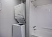 Thumbnail 31 of 50 - White washer and dryer in a bathroom with a shower and a sink  at Governor's Park, Fort Collins, 80525
