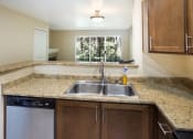 Thumbnail 8 of 31 - A kitchen with a sink and a dishwasher at Arcadia Townhomes, Federal Way, WA