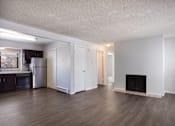 Thumbnail 20 of 50 - Empty living room with a fireplace and a kitchen  at Governor's Park, Fort Collins, 80525