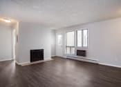 Thumbnail 18 of 50 - Empty living room with a fireplace and wooden floors  at Governor's Park, Fort Collins, 80525