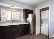 Thumbnail 10 of 50 - Empty kitchen with a washer and dryer in closet  at Governor's Park, Fort Collins, 80525