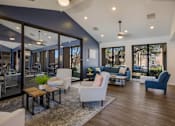 Thumbnail 18 of 23 - Resident lounge with couches and chairs at Mountain Run Apartments, New Mexico, 87111