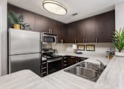 Thumbnail 12 of 43 - Kitchen with stainless steel appliances at University Ridge Apartments, Durham, NC, 27707