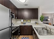 Thumbnail 13 of 43 - Spacious kitchen is equipped with stainless steel appliances and granite like counter tops at University Ridge Apartments, Durham, NC, 27707