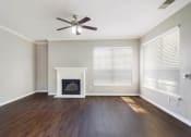 Thumbnail 2 of 17 - Living Room with Ceiling Fan and Fireplace at Bridford Lake Apartments, Greensboro, North Carolina