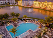 Thumbnail 81 of 86 - Sunset Drone View of Buildings, Pool, and Lake at Edge75, Naples, FL 34104