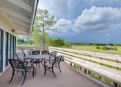 Thumbnail 20 of 24 - Outdoor Seating with Green Views at River Crossing Apartments, Thunderbolt, GA