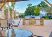 Thumbnail 10 of 24 - Picnic Seating Area at River Crossing Apartments, Georgia, 31404