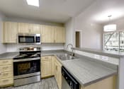 Thumbnail 47 of 105 - Granite Countertop Kitchen at Sweetwater At Metro North Apartments, Phoenix, Arizona