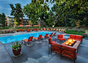 Thumbnail 23 of 37 - Poolside Lounge Area With Firepit at Woodland Hills Apartments, Colorado Springs