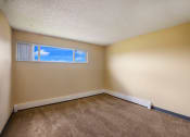 Thumbnail 19 of 33 - a bedroom with beige walls and a window at Broadmoor Springs, Colorado Springs, CO, 80906