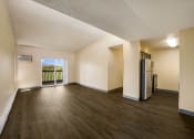 Thumbnail 27 of 33 - an open living room with a balcony and refrigerator at Broadmoor Springs, Colorado Springs, CO, 80906
