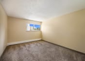 Thumbnail 31 of 33 - an empty bedroom with a small window at Broadmoor Springs, Colorado Springs, CO, 80906