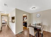 Thumbnail 1 of 16 - a dining room with a table and chairs and a clock on the wall at The Glen, Texas, 75067