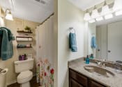 Thumbnail 5 of 16 - a bathroom with a sink and a toilet and a mirror at The Glen Apartments, Texas, 75067