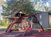 Thumbnail 35 of 41 - A wooden swing set in a backyard at North Creek Apartments, Everett, Washington, 98208