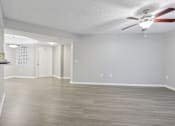 Thumbnail 15 of 50 - an empty living room with a ceiling fan at Pembroke Pines Landings, Pembroke Pines, FL 33025