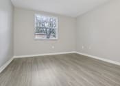 Thumbnail 26 of 50 - an empty room with wood floors and a window at Pembroke Pines Landings, Florida